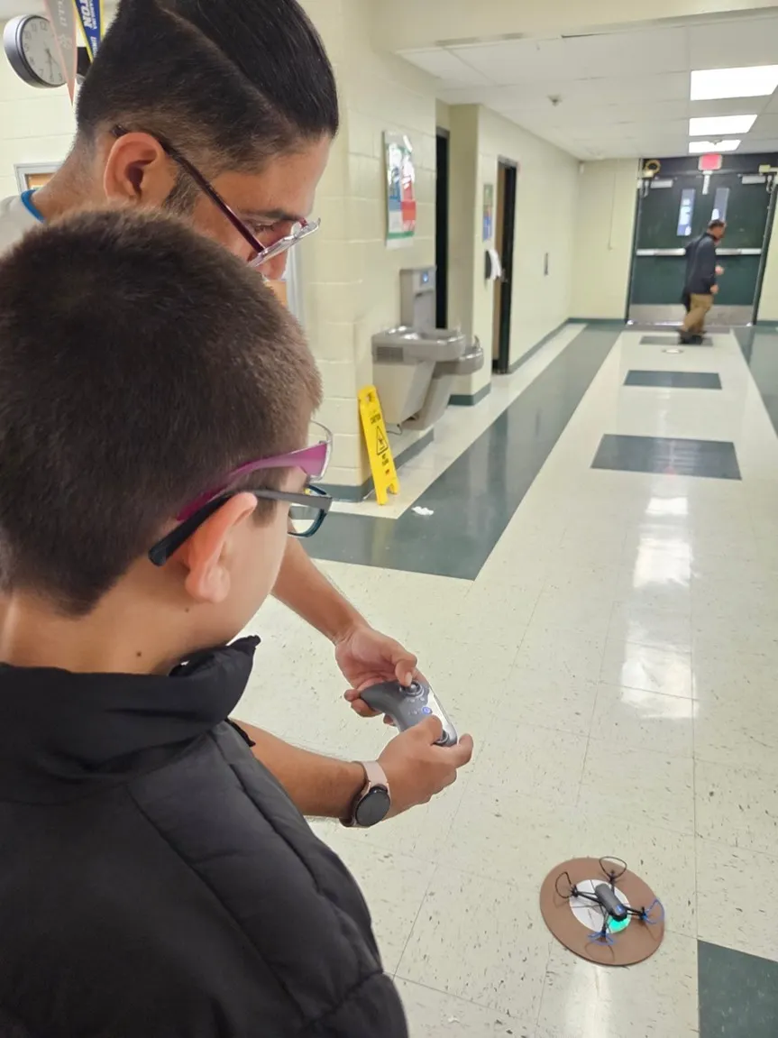 Back of student&#x27;s head experimenting with STEM drone project.