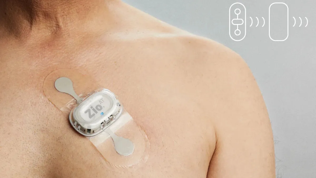 The Xio AT cardiac monitor worn on a man's hairless chest