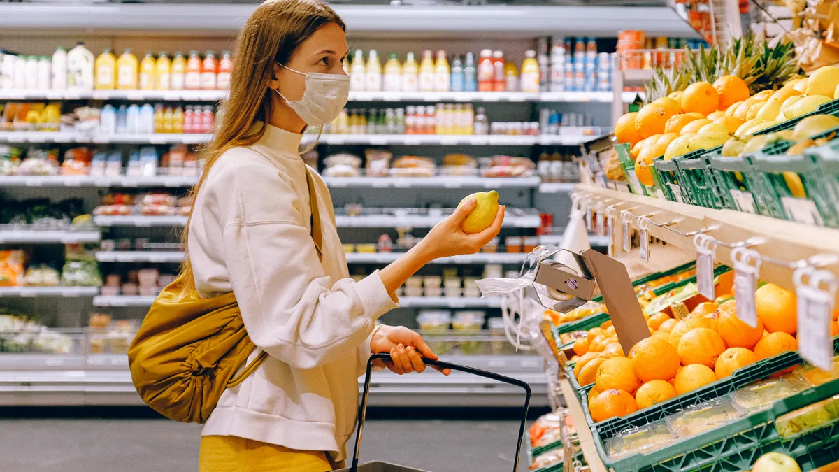 Stock photo of a masked grocery shopper