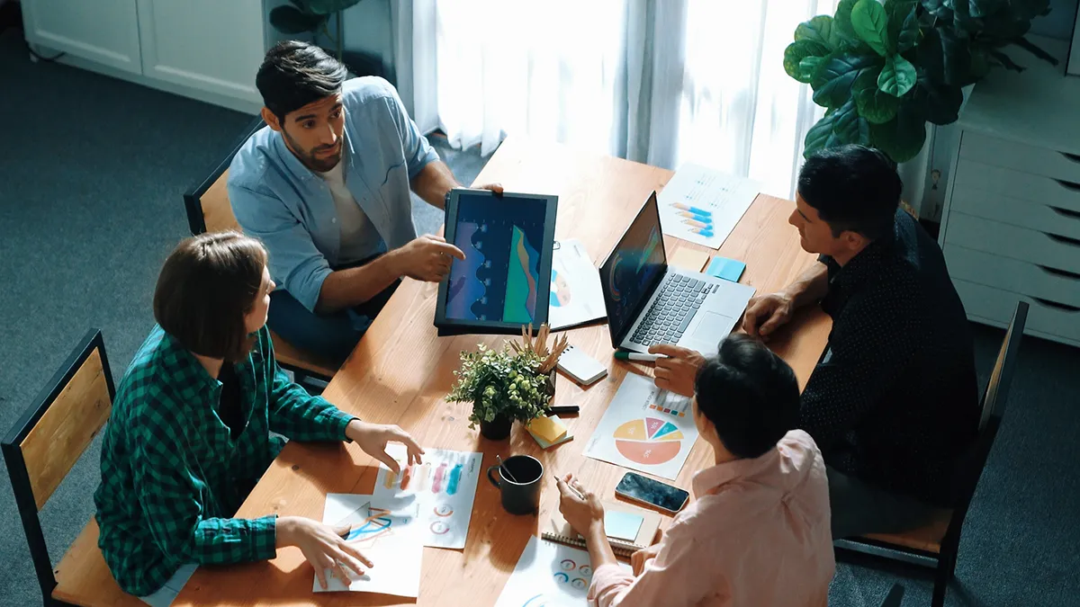 Top view of businesspeople discuss idea while team joining meeting