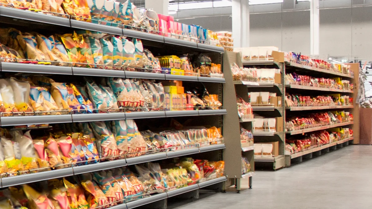 Bagged snack foods in a grocery store aisle.