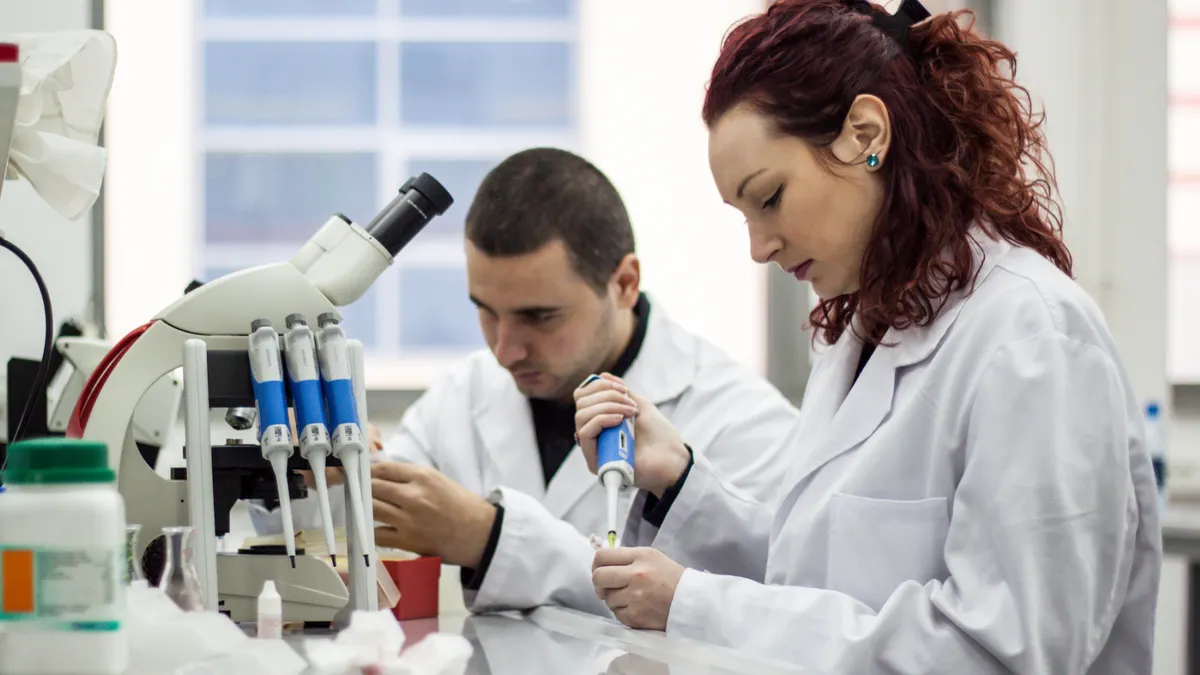Scientist working with pipette in biotechnology laboratory