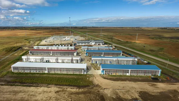 An aerial view of several buildings in a wide open plain.