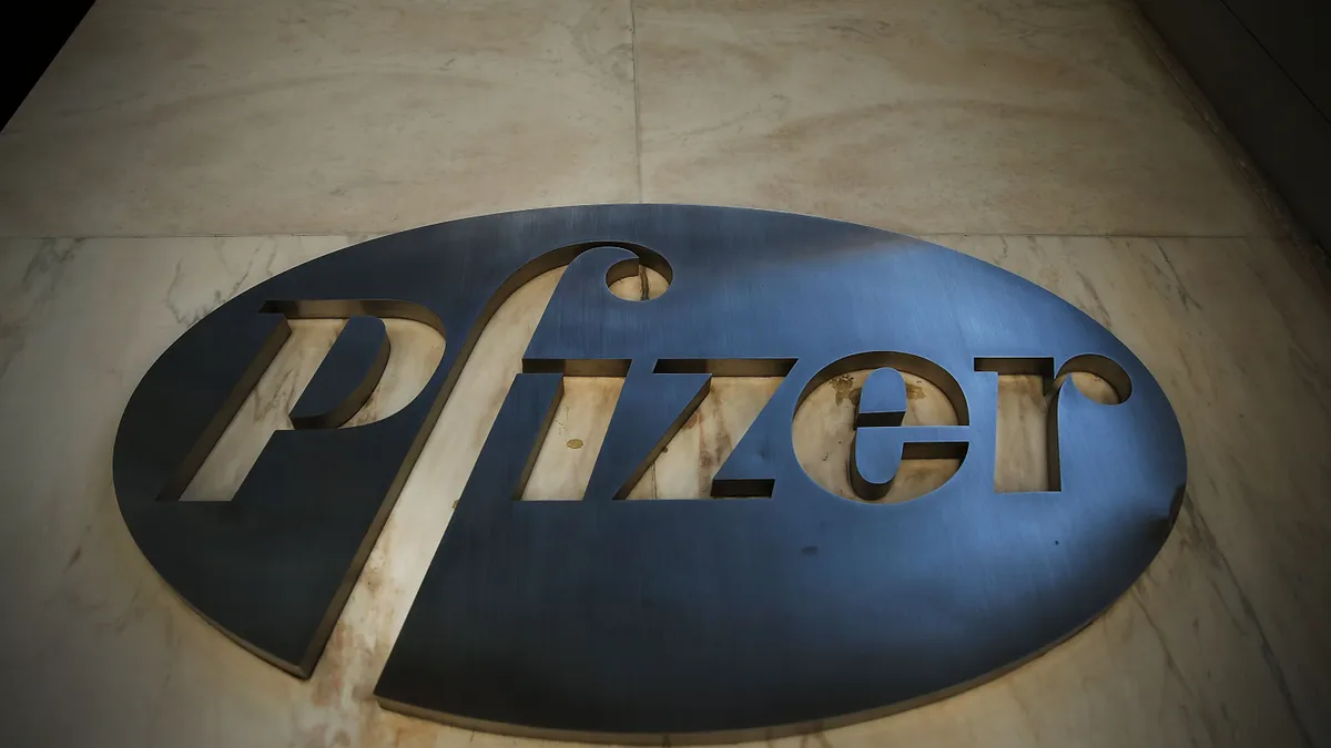 A view of Pfizer's steel logo from below.