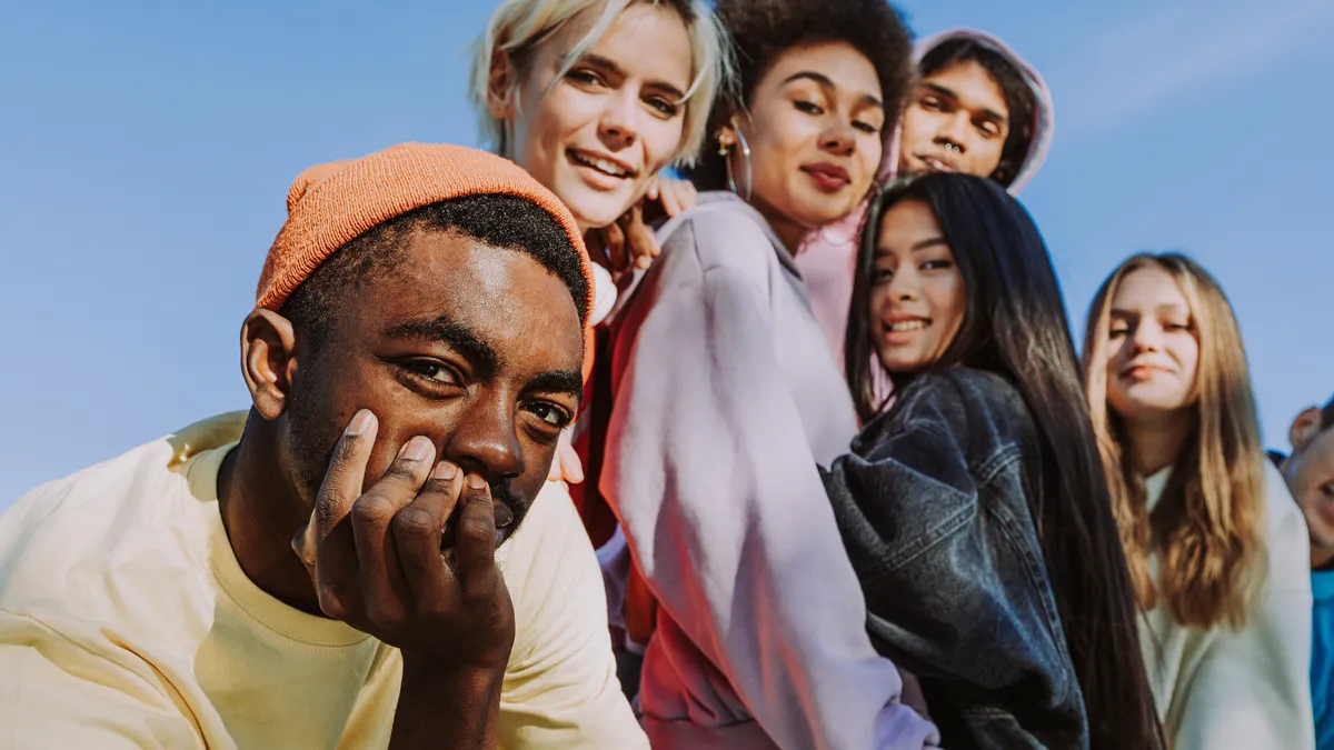 Multicultural group of young friends bonding outdoors