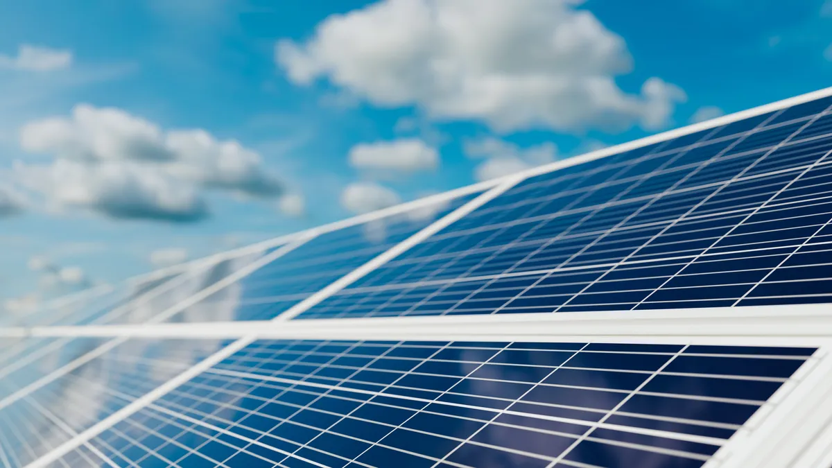 Solar panel recharging clean energy at midday with blue sky and clouds, ecology and sustainability