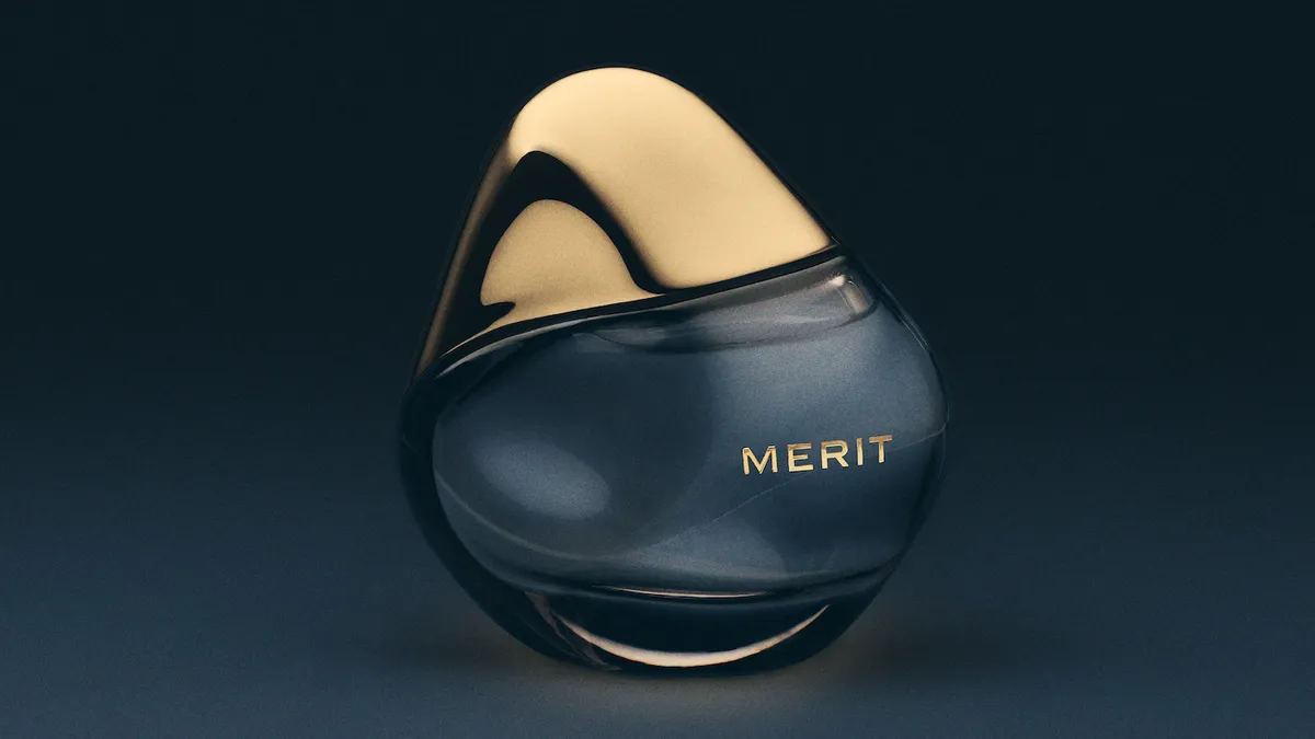 A bottle of Merit's Retrospect fragrance with a dark background