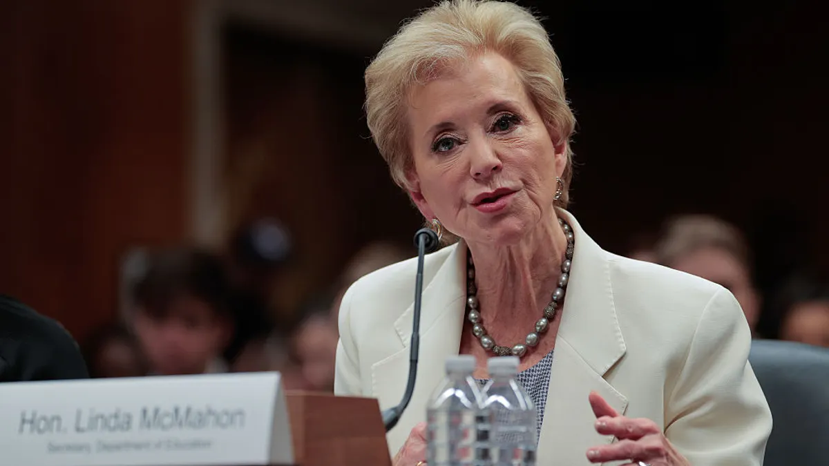 Linda McMahon speaks while seated at a podium.