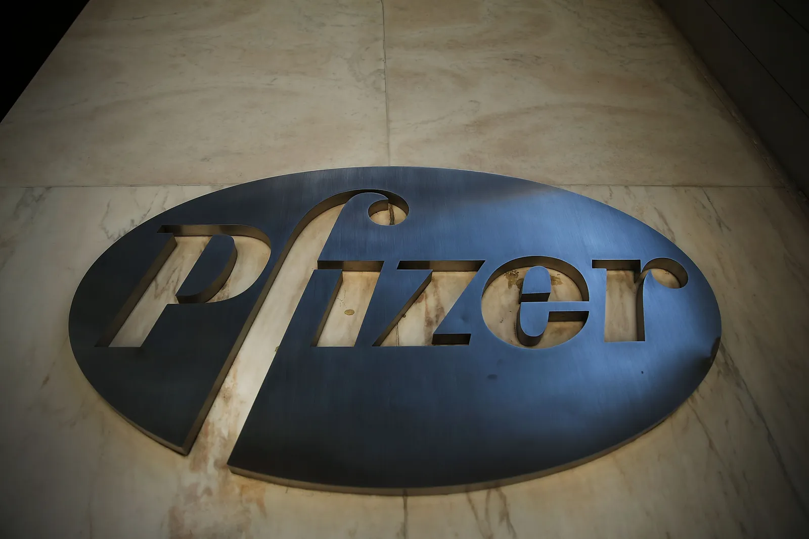 A view of Pfizer's steel logo from below.