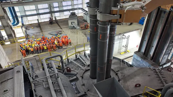 Algoma Steel workers stand in front of the company's new electric arc furnace.