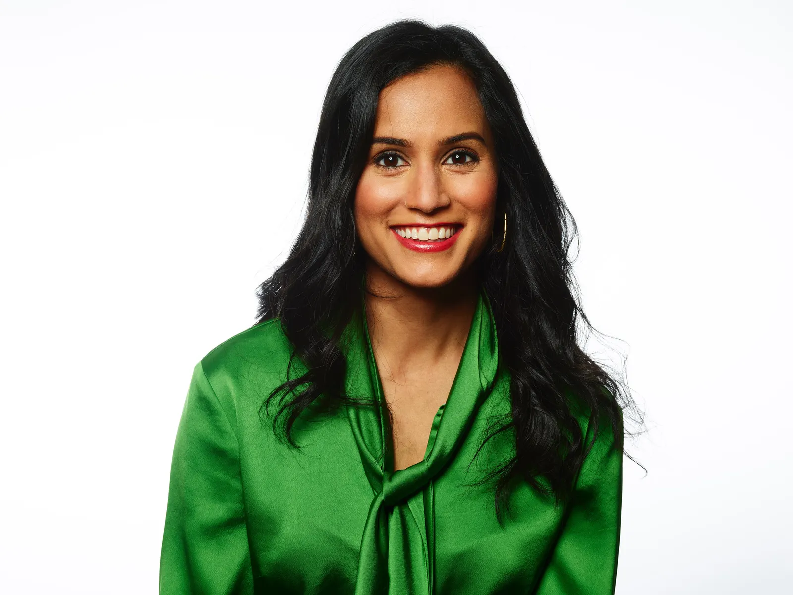 Marketing executive Bindu Shah wears a green shirt against a white background in a headshot photo