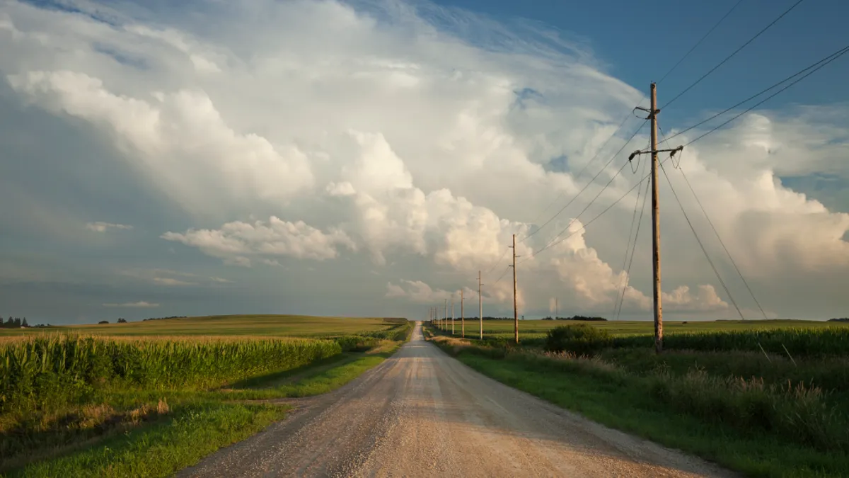 Rural road with dramatic clouds in southern Minnesota at sundown