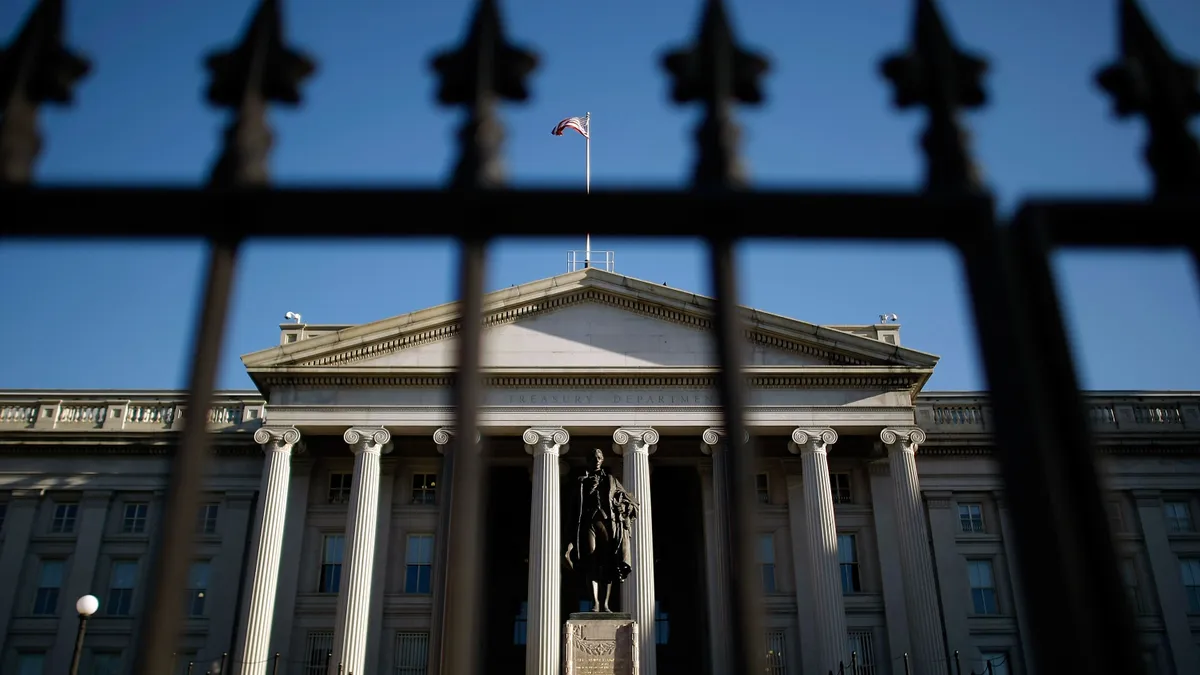 A statue of the first Secretary of the Treasury Alexander Hamilton stands in front of the U.S. Treasury Department building.