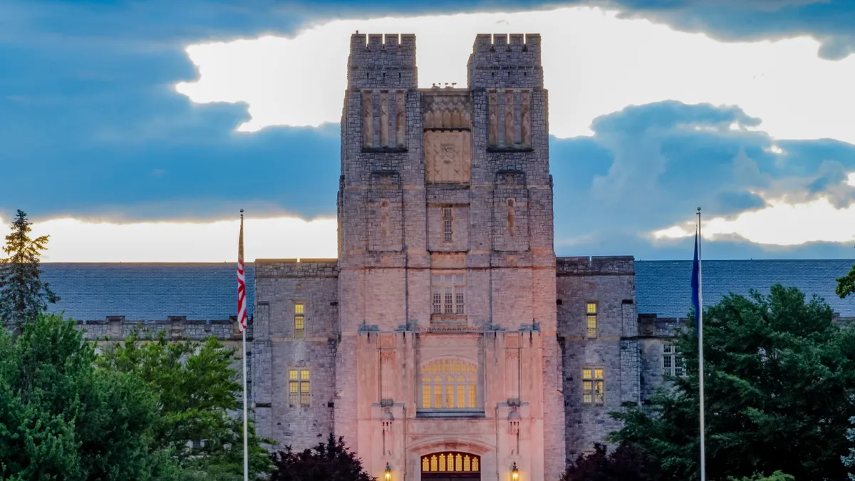 A tall, academic building is seen from street view.