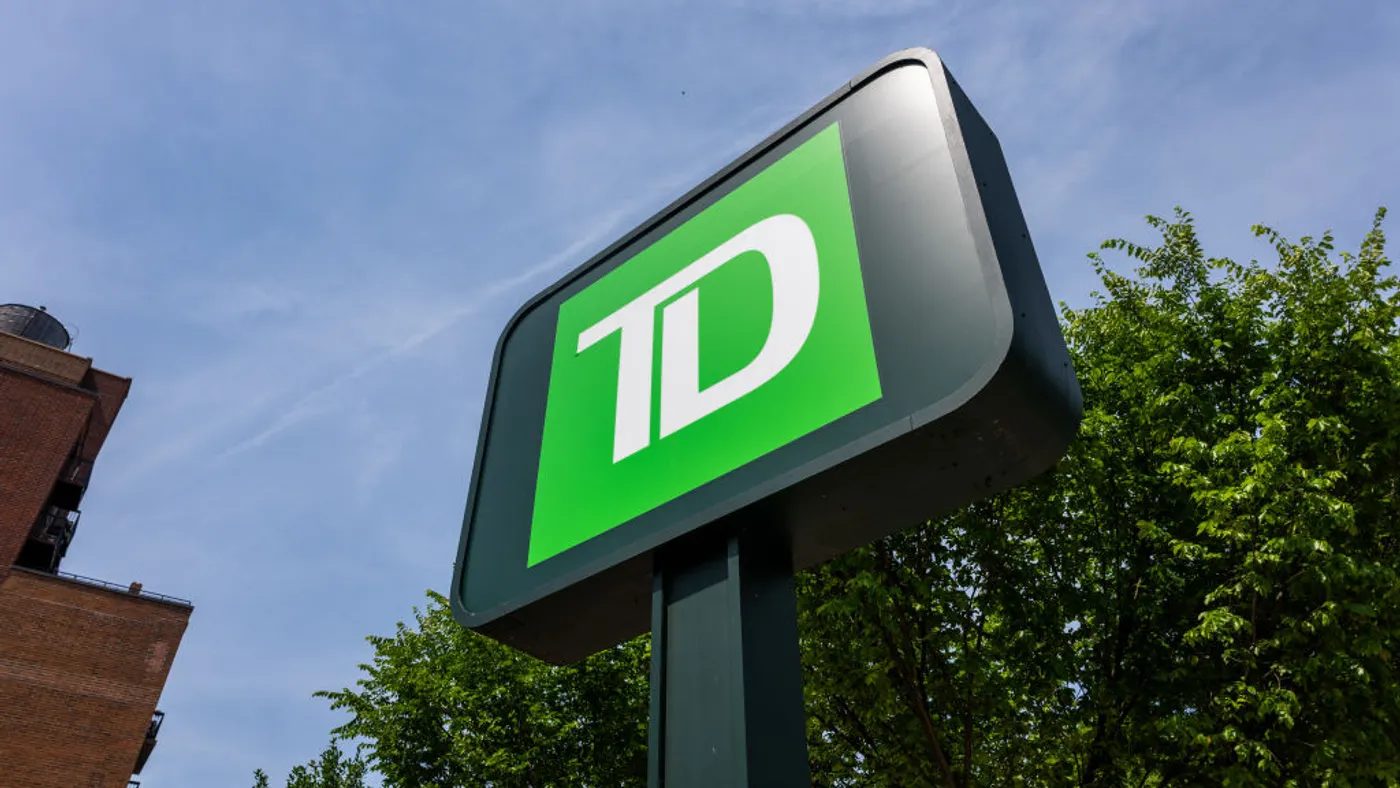 A green sign depicts a bright green background and white letters "TD"