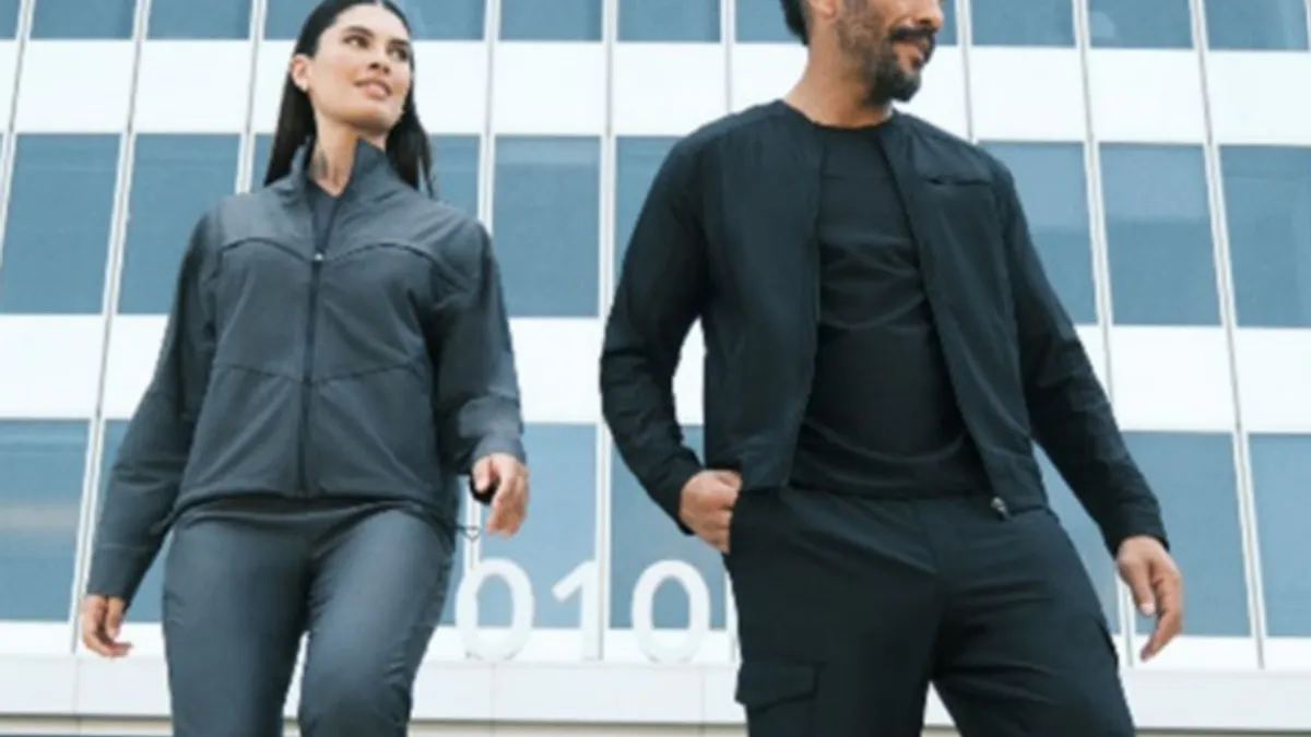 Male and female models in Careismatic-made scrubs in front of a building