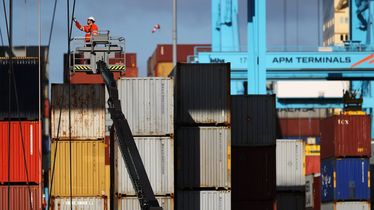 A general view of workers in the yard working on shipping containers and the cranes which move them at the Port of Rotterdam on October 27, 2017.