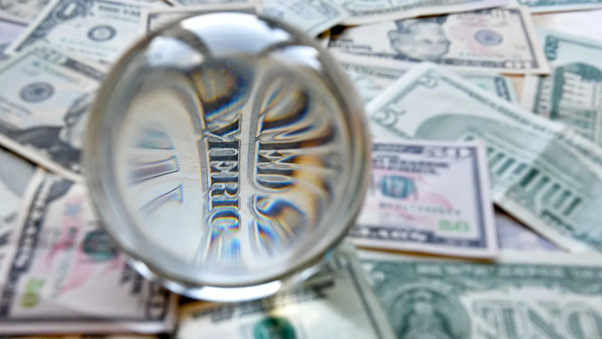 US dollar bill seen through a crystal ball. Creative concept, business, banking, taxes and finance