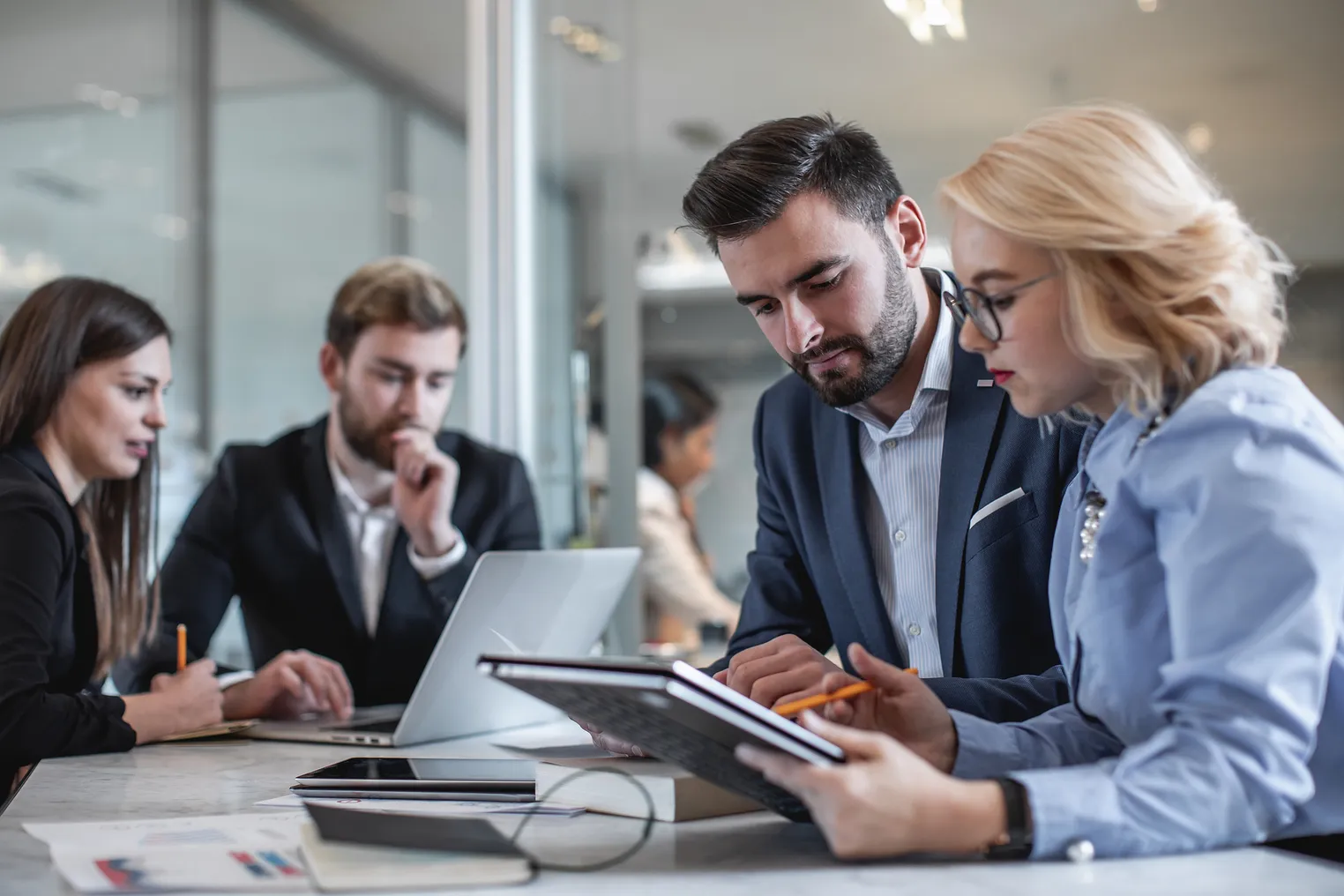 Business people in a meeting around a tablet