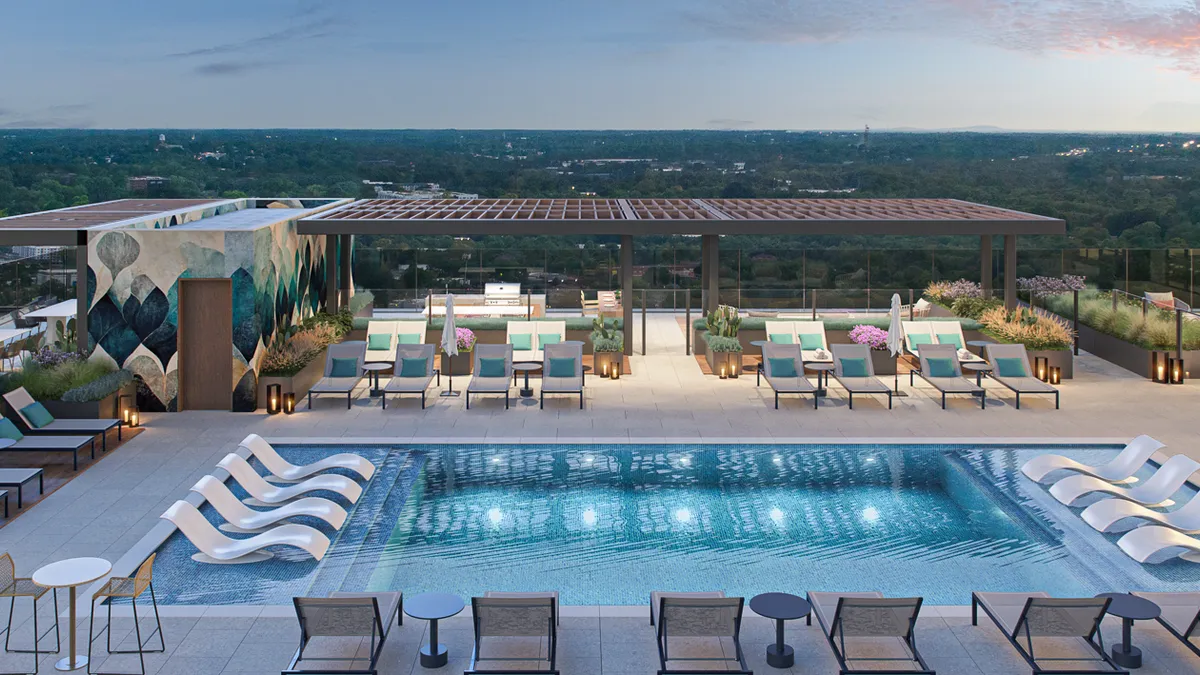 A rooftop pool deck with lounge chairs.