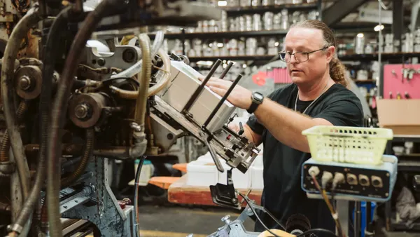A person works with industrial equipment.