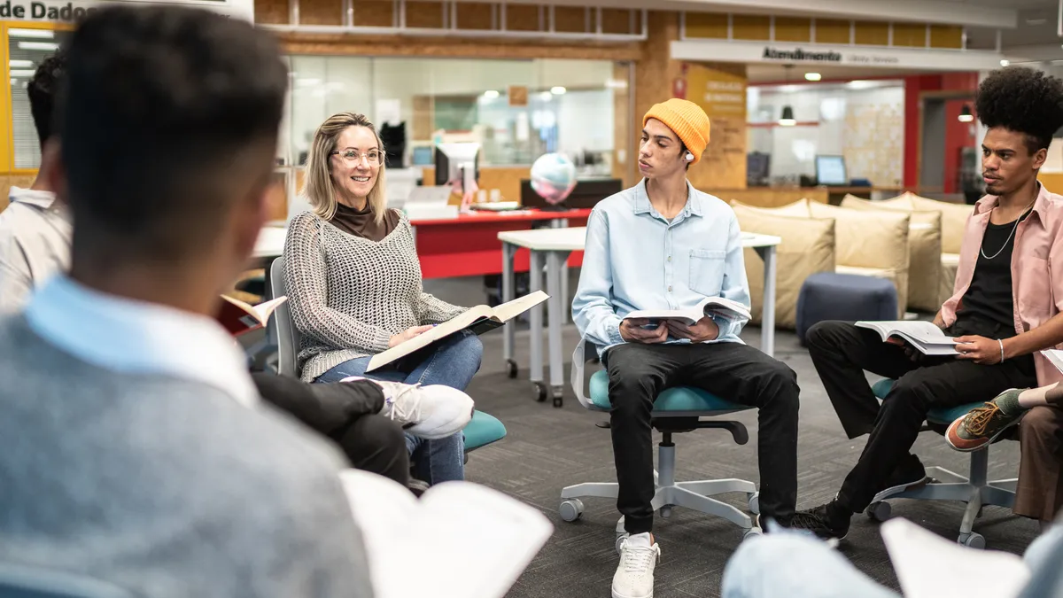 A group of employees sits in a circle and chats.