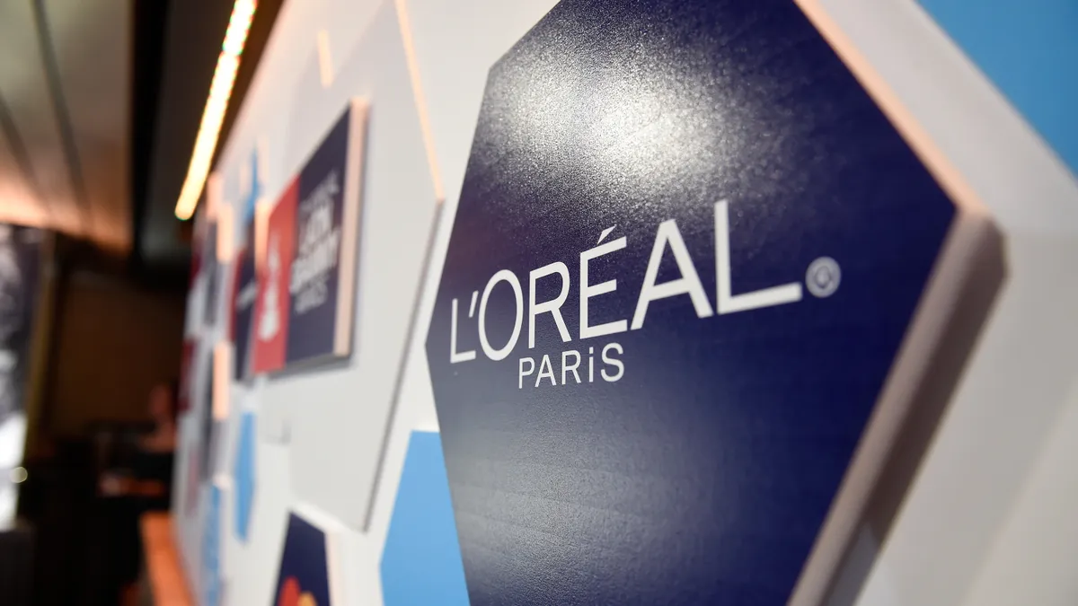 L'Oreal signage is displayed on a wall.