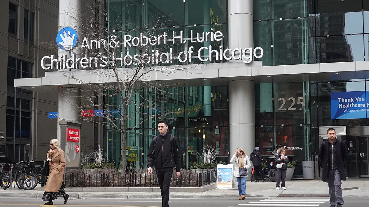 People walk past an entrance to a hospital in Chicago.