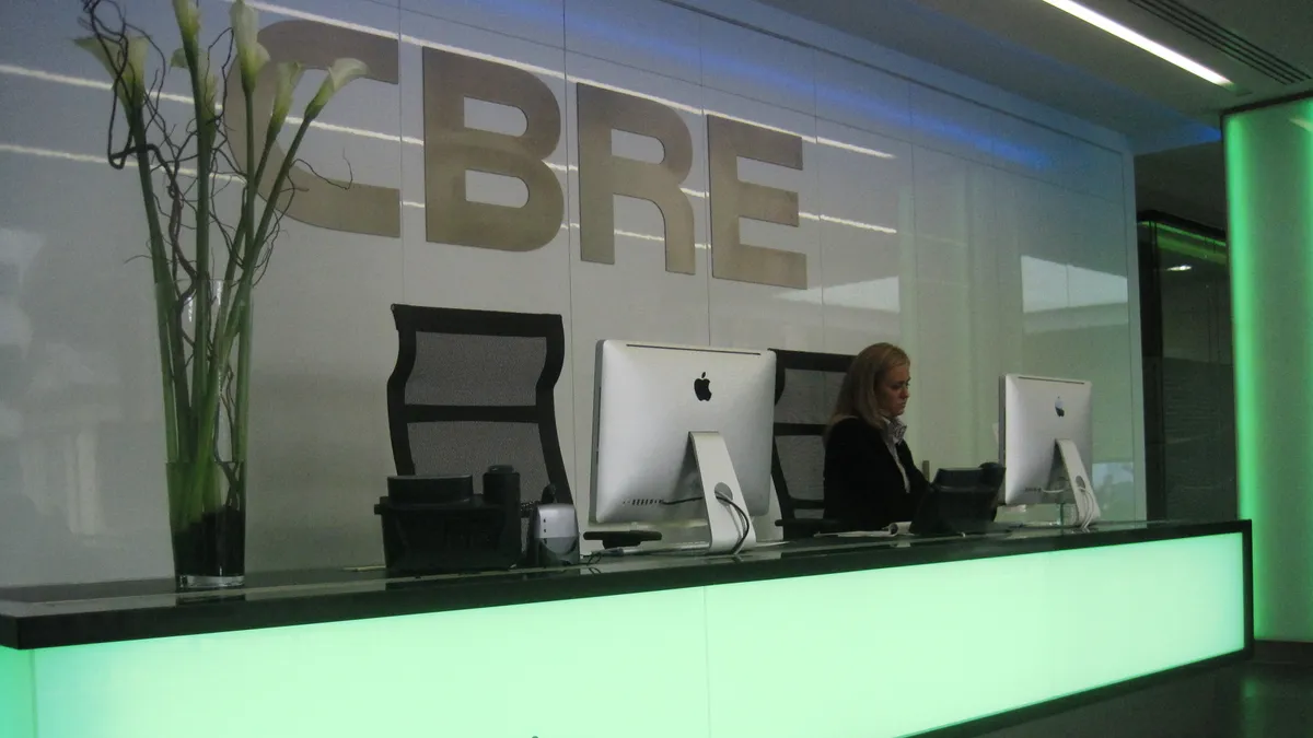 A front reception desk at a CBRE office.