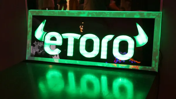 neon green etoro sign on black background in miami