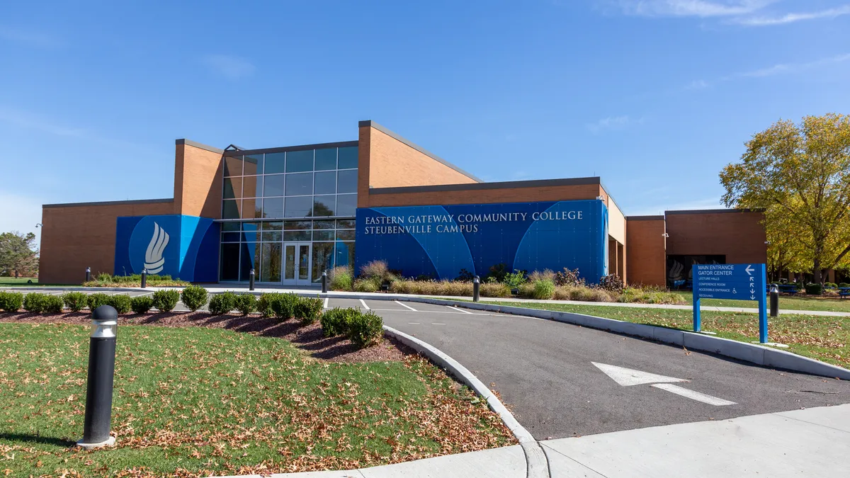 A brick-and-glass building is wrapped in a blue sign reading "Eastern Gateway Community College Steubenville Campus."