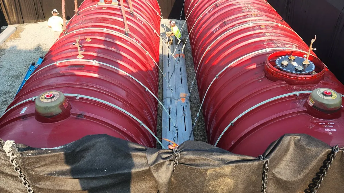 A photo of workers installing an underground storage tank.