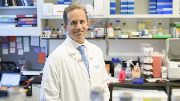 A man poses in a laboratory setting.