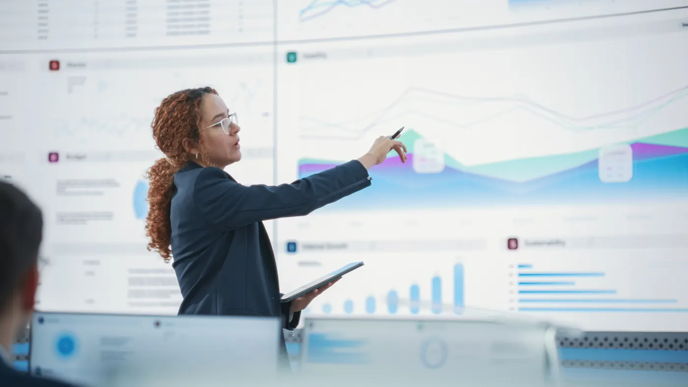 Data Scientist Reviewing Reports Of Risk Management Department