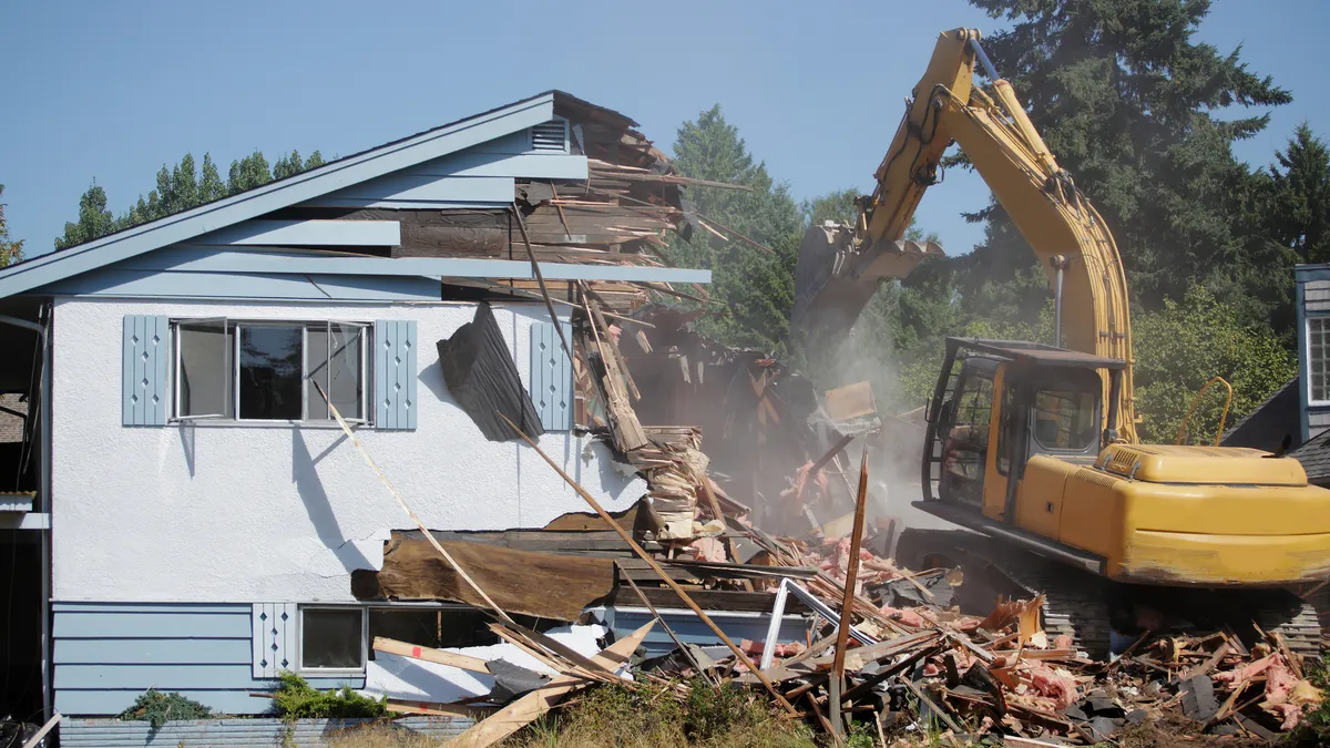 A crane demolishing a house