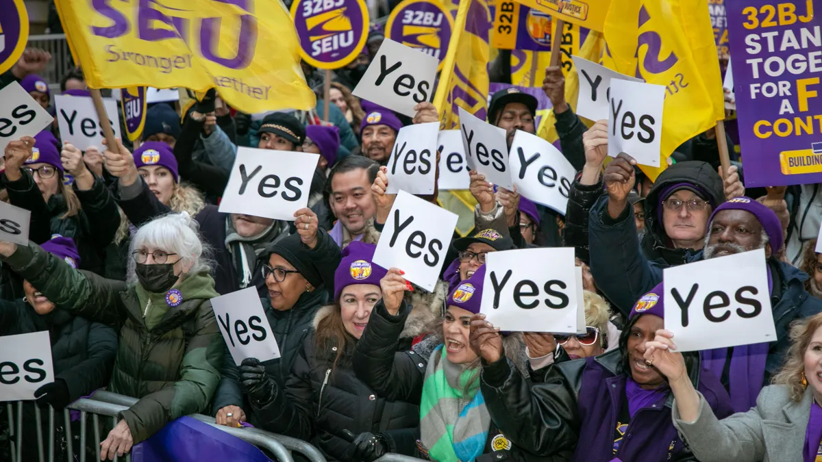 Thousands of bargaining committee members, including commercial cleaners and porters, rally in New York City in December 2023, seeking higher wages and improved benefits.