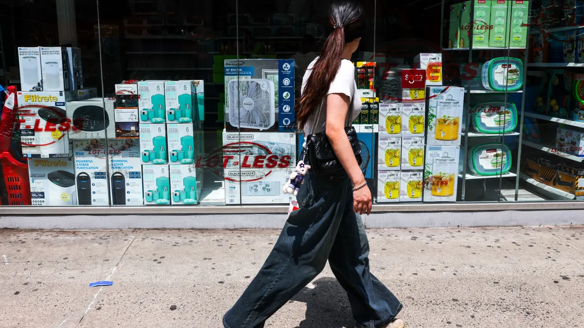 A person walks past a storefront.