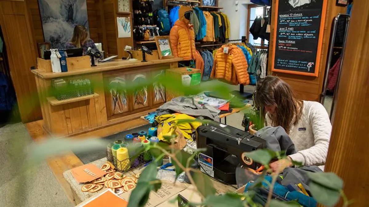 A person uses a sewing machine.