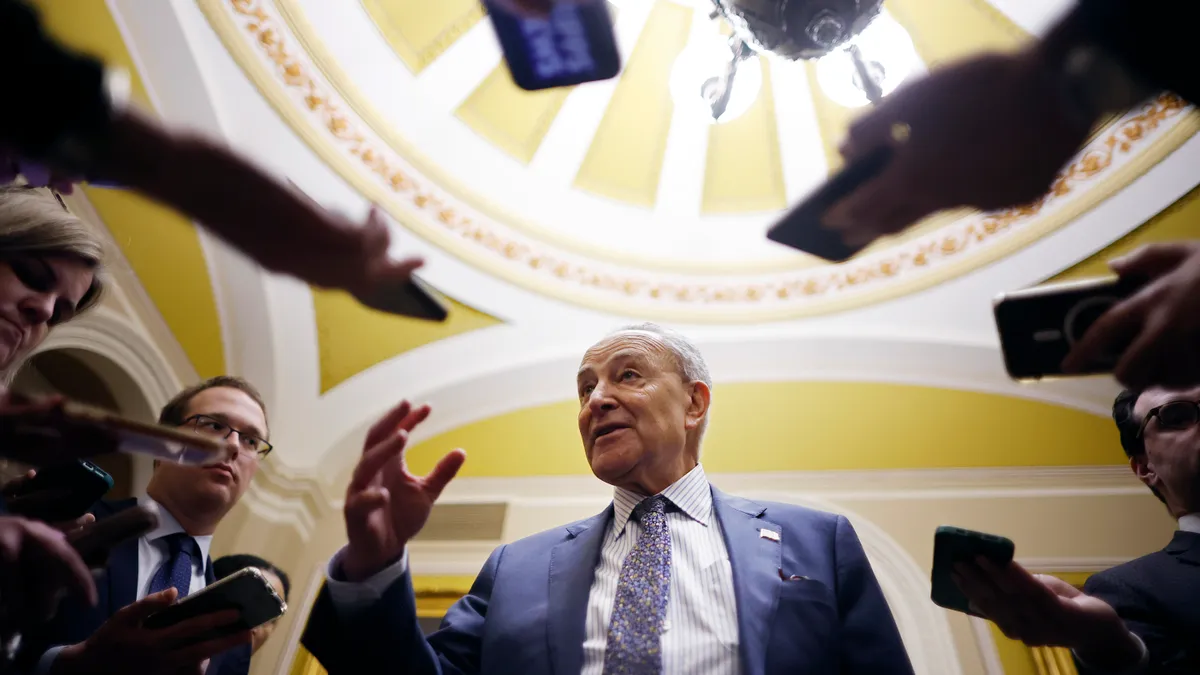 Chuck Schumer is seen speaking with reporters