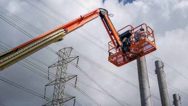 Service technicians work to install transmission towers.