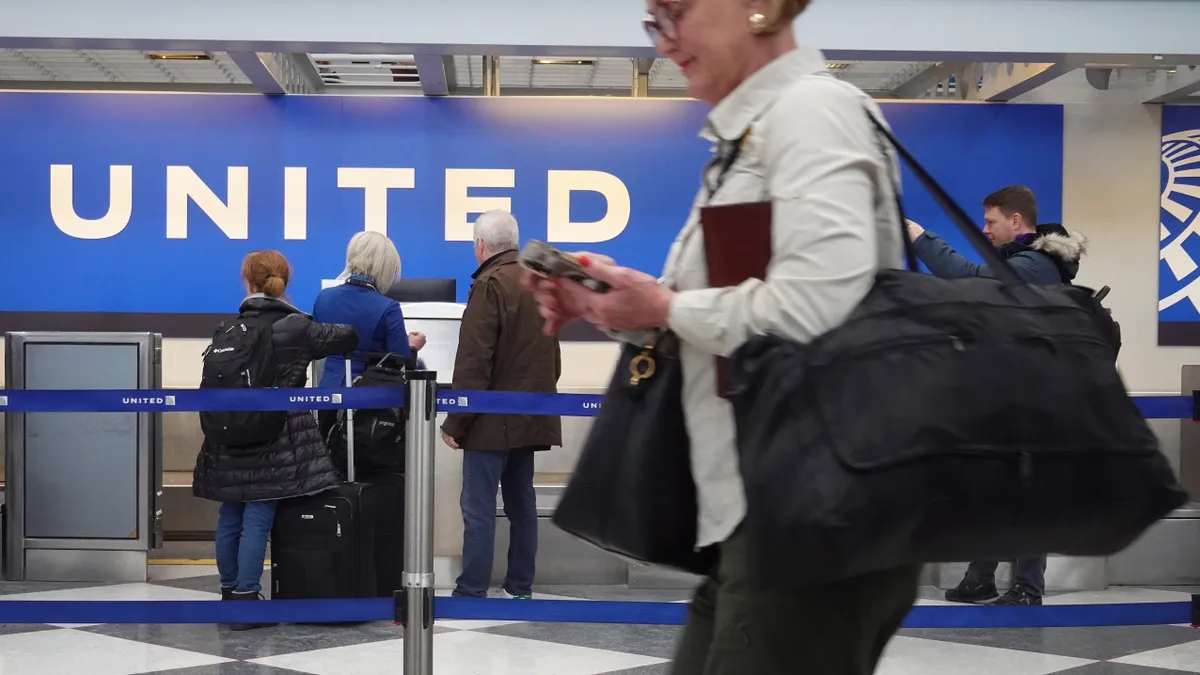 Passengers check in for United Airlines flights at the airport