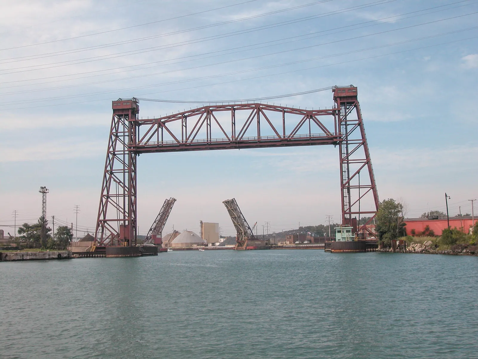 A lift bridge in the foreground frames another movable span in the background.