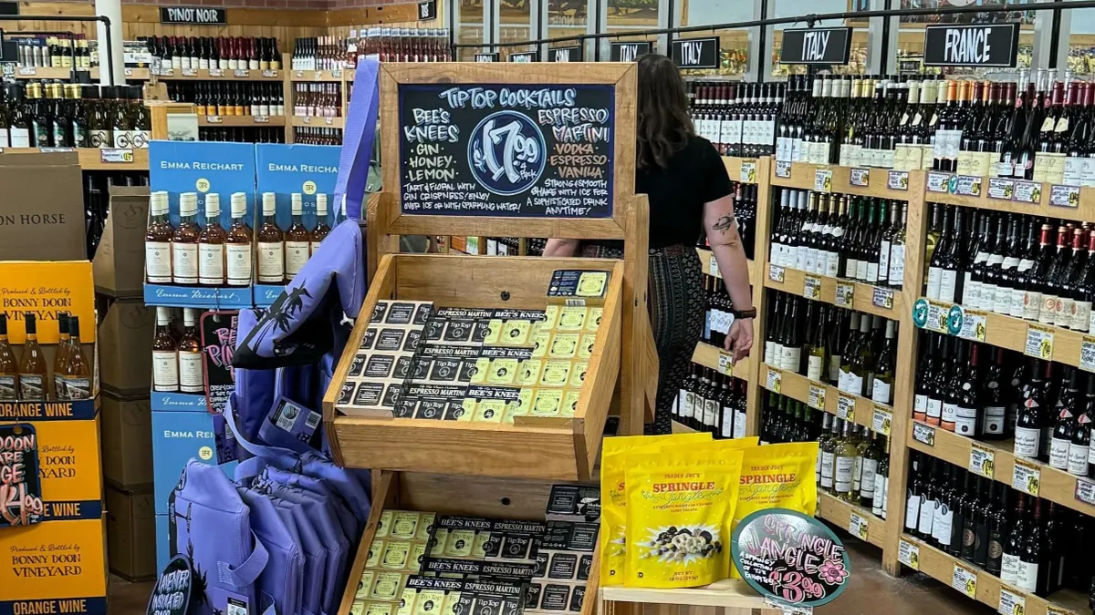 Canned alcoholic beverages in wooden boxes in a grocery store