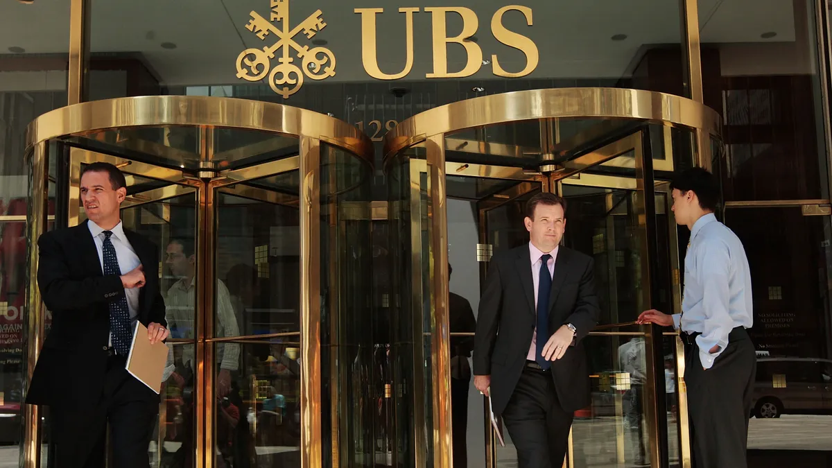 People enter and exit UBS Bank in NYC.