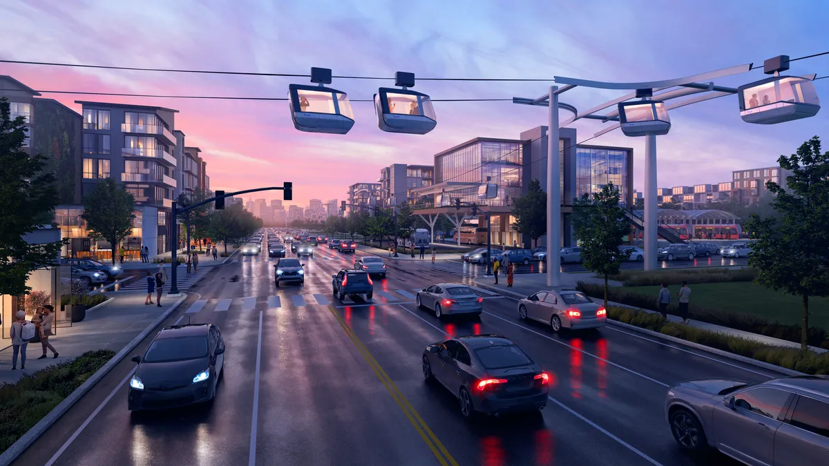 Gondolas on cables over a city street with car and pedestrian traffic