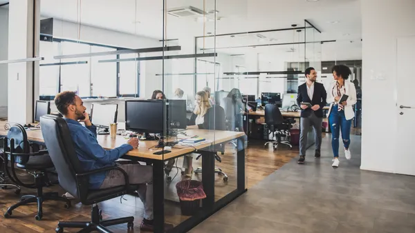 A group of employees work in a modern office.