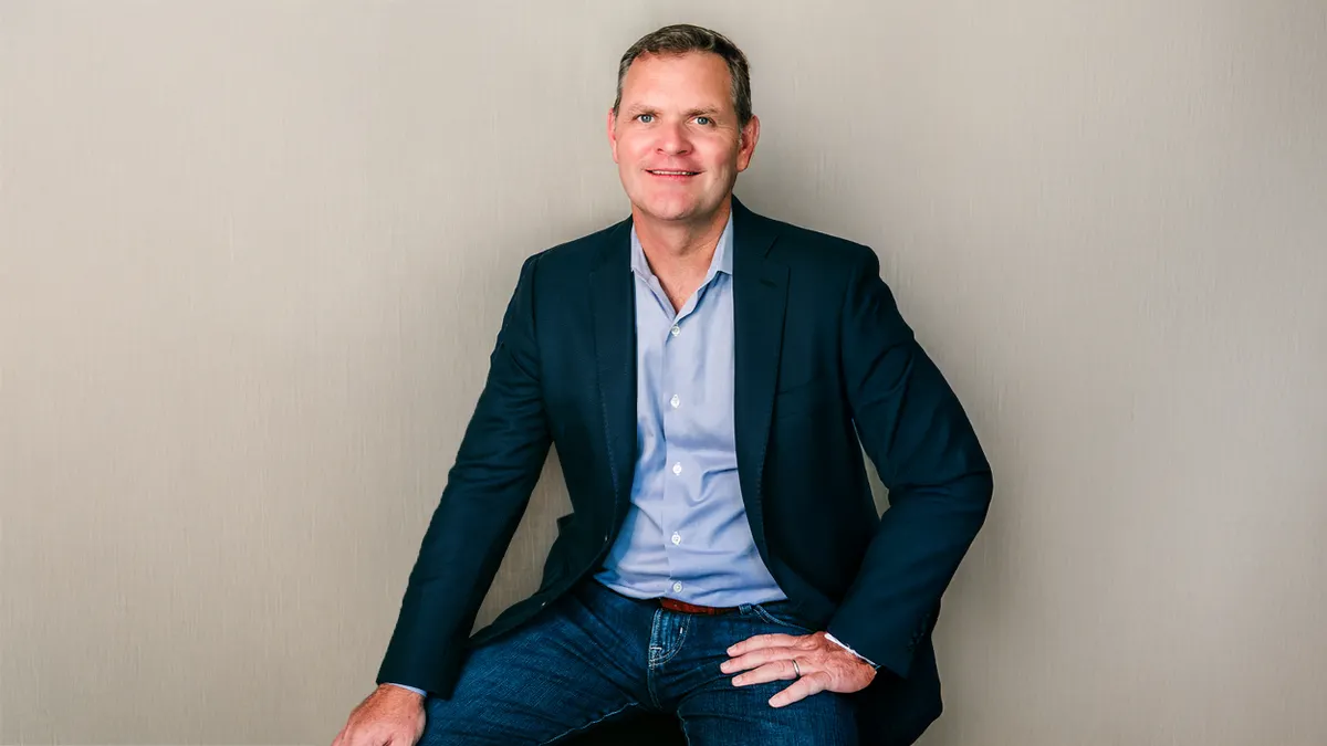 Steven Axon, Glycomine's CEO, shown in front of a gray backdrop.