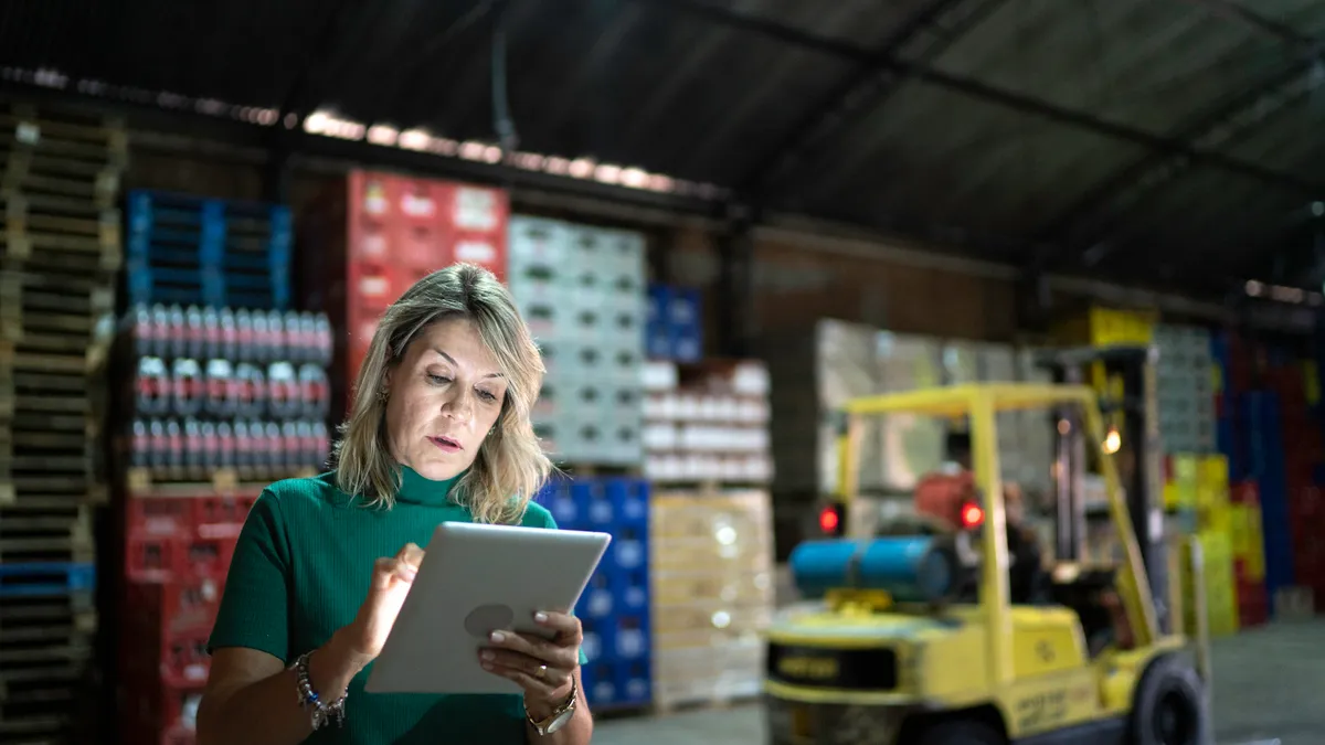 Employee using digital tablet at warehouse