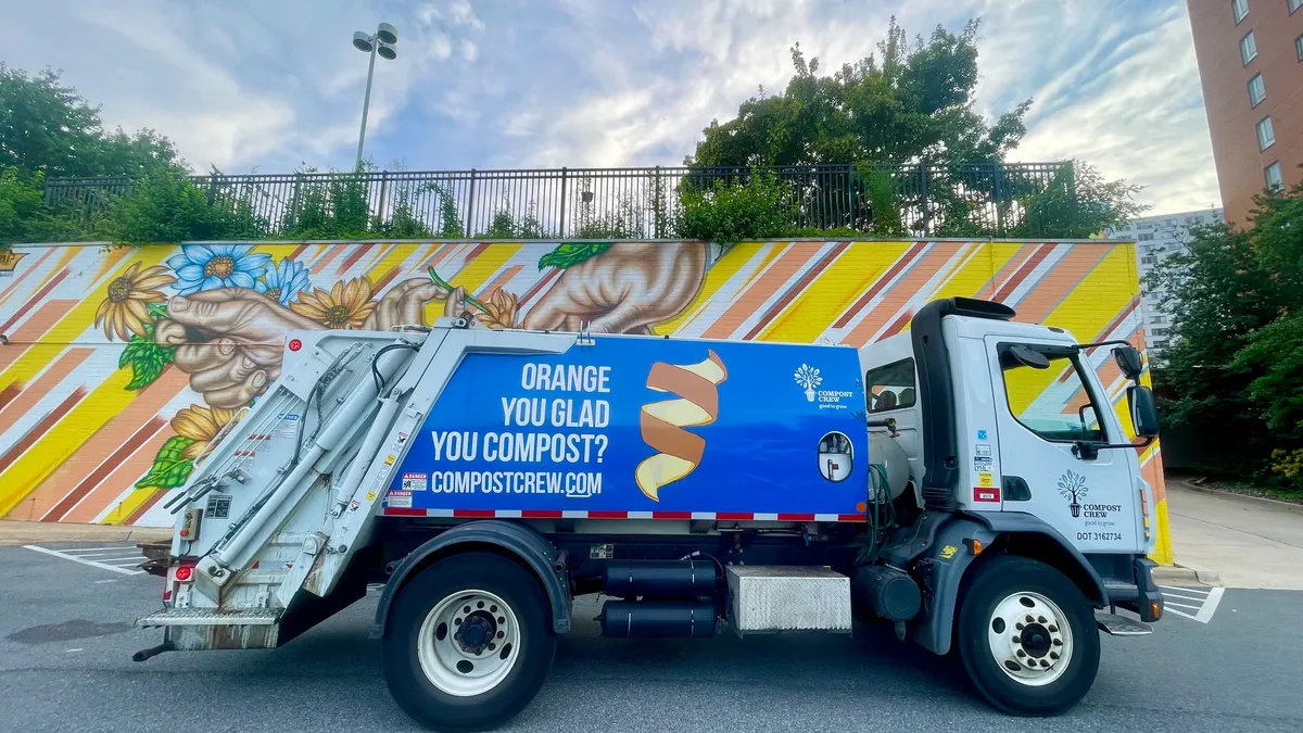 Photo of small organics collection truck with the slogan "Orange You Glad You Compost?"