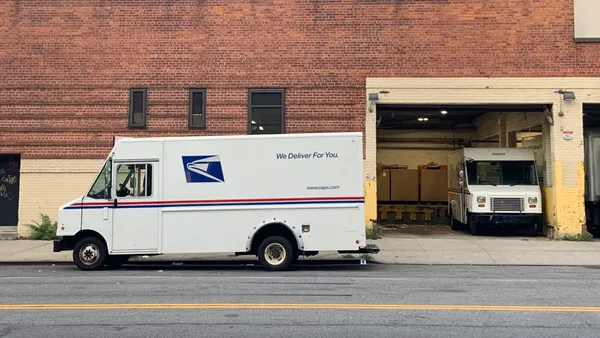 A U.S. Postal Service van on the road.